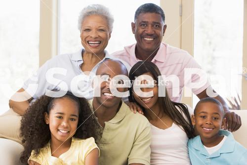 Extended Family Sitting On Sofa